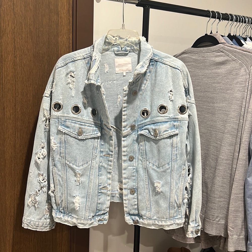 Light blue jean jacket with metal details.
